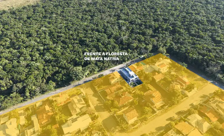 Aerial view of Casas Açores bordering native Atlantic forest in Pântano do Sul, Florianópolis